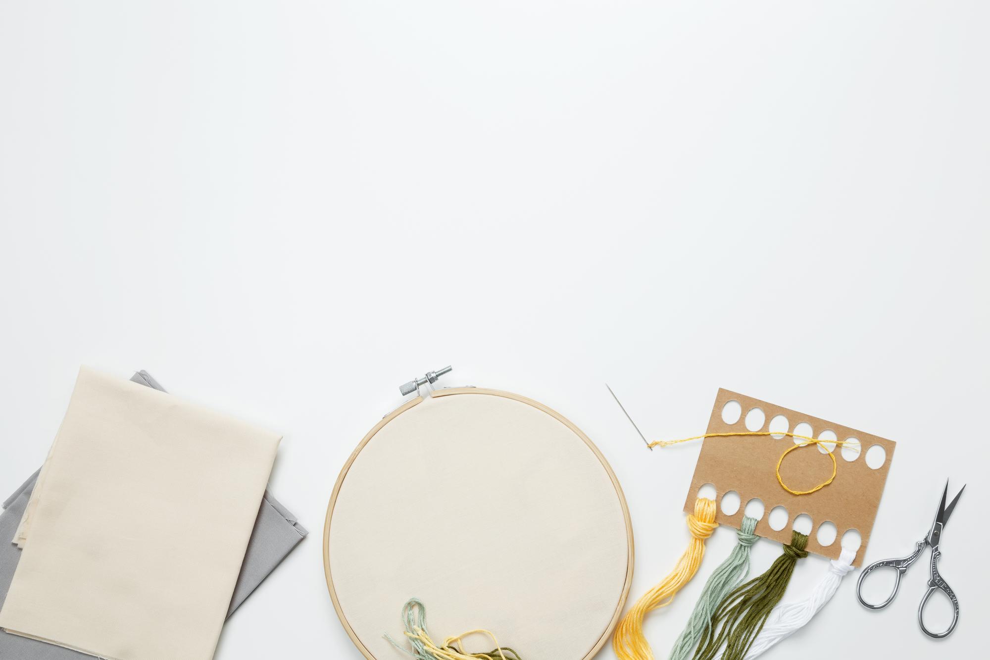 Studio view with embroidered samples on table