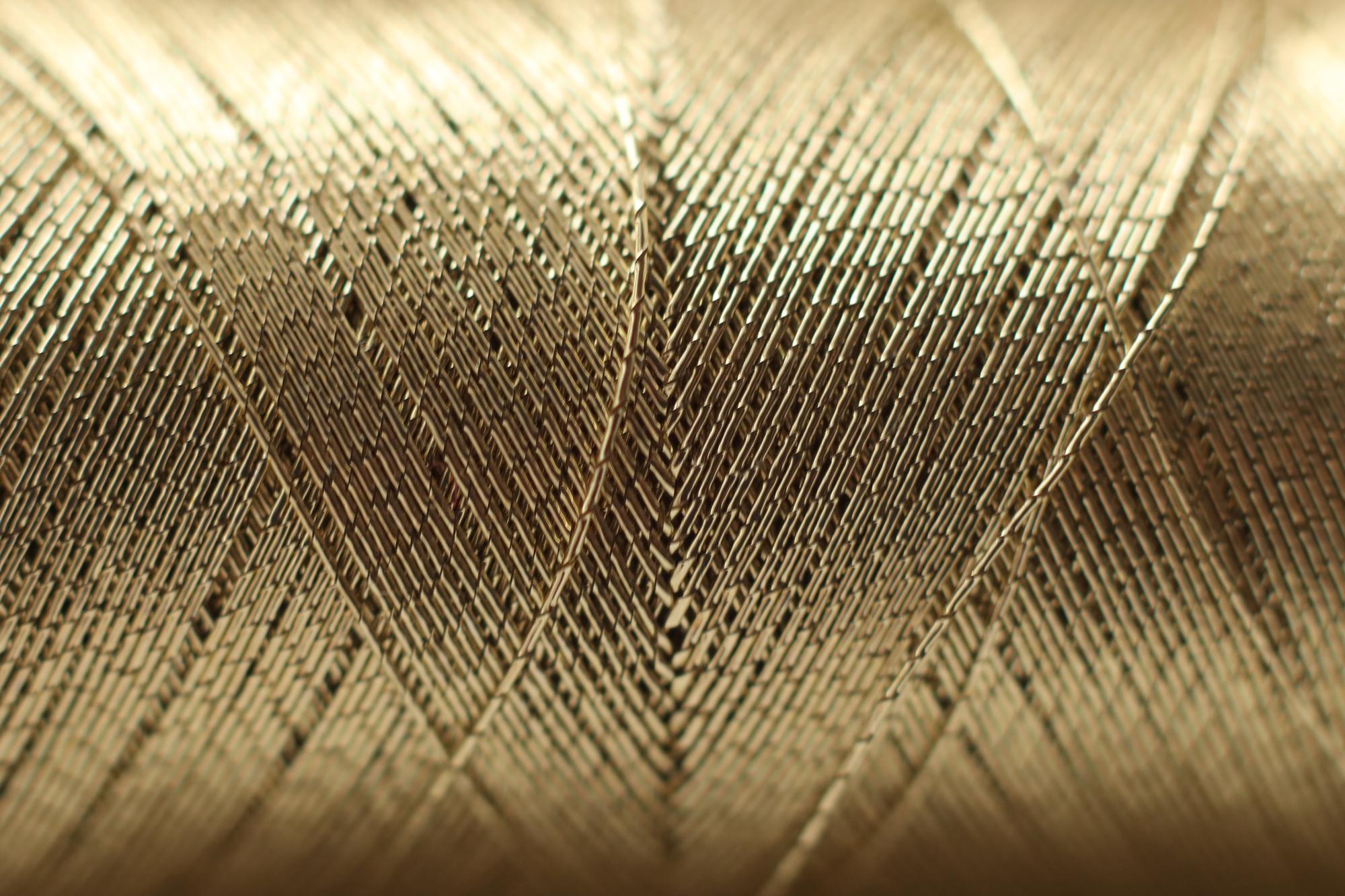 Close-up of luxury embroidered linen with gold thread
